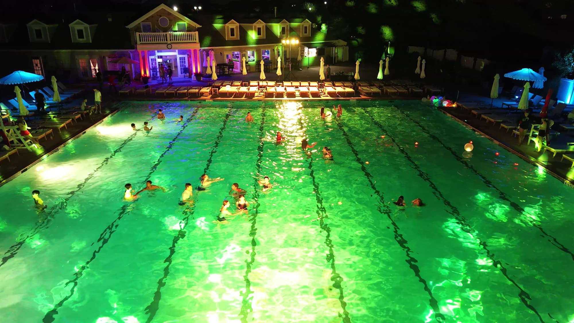 Gallery: the pool lit at night during an event. Currently the best frame from the Bold Productions drone footage.